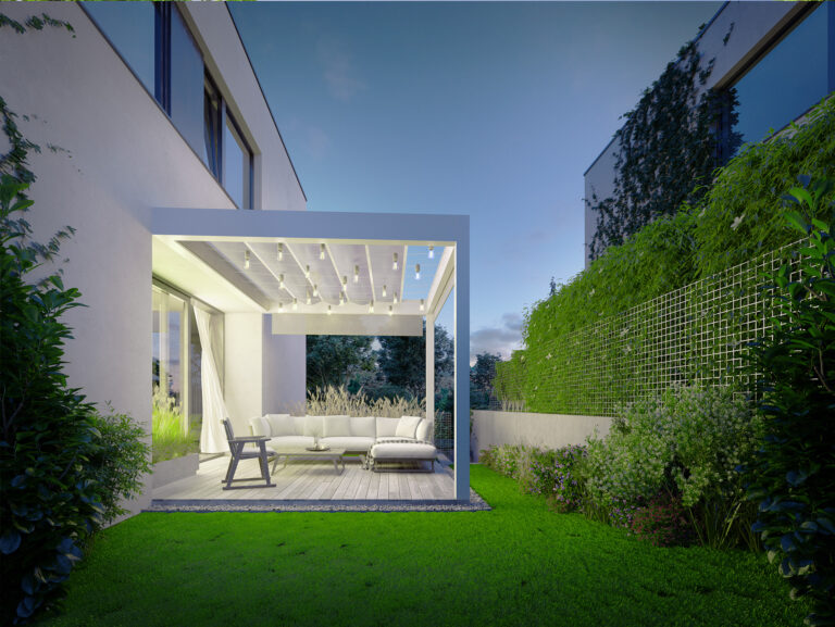 a white patio with a white couch and a white chair in a yard